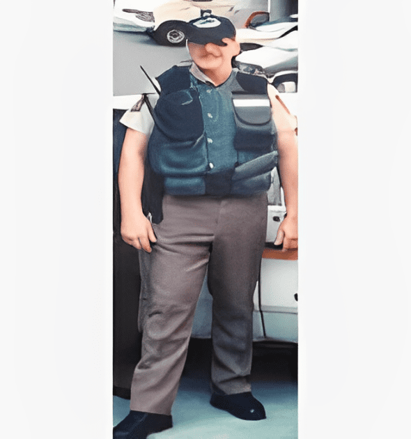 A man in uniform standing next to a car.