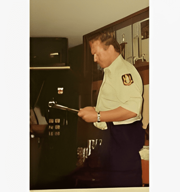 A man in uniform holding a tablet computer.